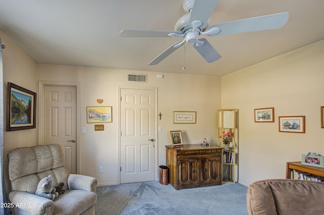 sitting room with baseboards, visible vents, carpet floors, and a ceiling fan