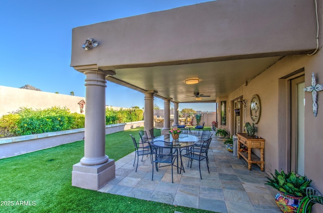 view of patio / terrace with fence, outdoor dining area, and ceiling fan