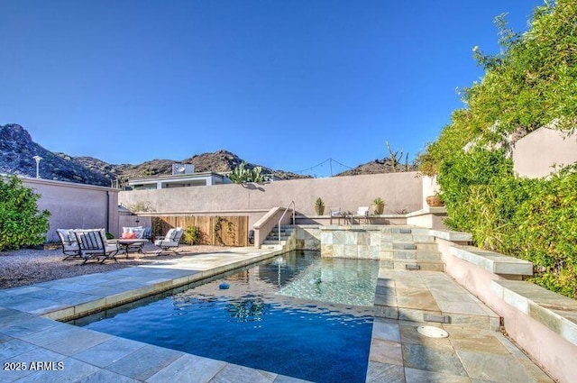 view of swimming pool with a patio, a mountain view, a fenced backyard, and a fenced in pool