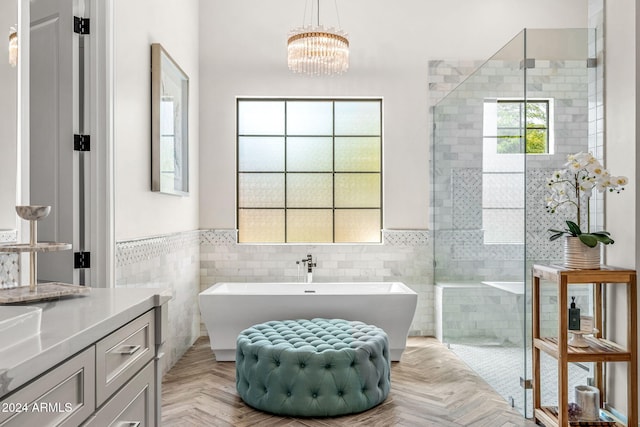 bathroom featuring vanity, separate shower and tub, and tile walls