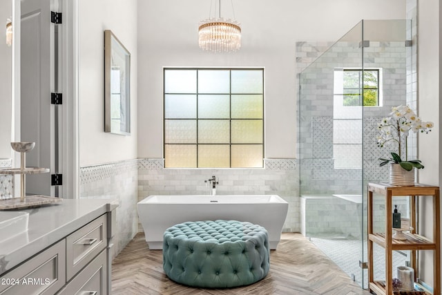 8742 E Villa Cassandra Dr, Scottsdale, AZ 85266 - full bath featuring tile walls, a wainscoted wall, vanity, an inviting chandelier, and a freestanding bath