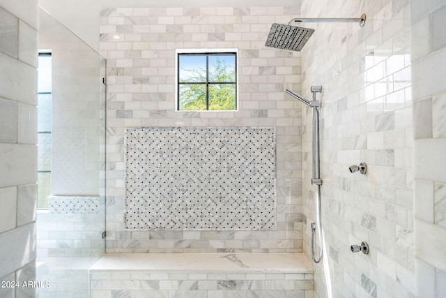 bathroom with a tile shower