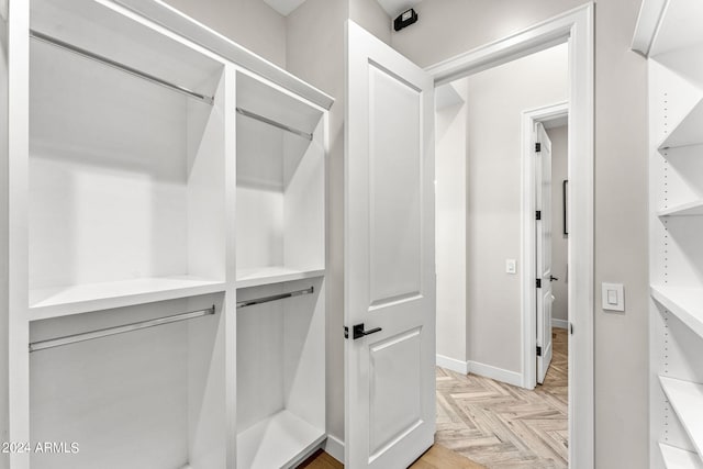 walk in closet featuring light parquet flooring