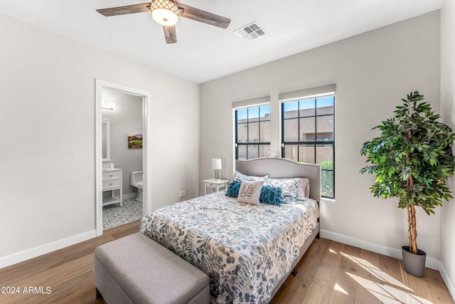 bedroom with hardwood / wood-style floors, connected bathroom, and ceiling fan