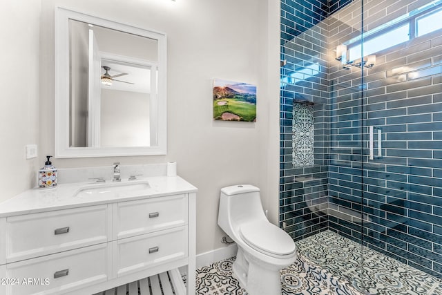 bathroom featuring ceiling fan, toilet, tile patterned floors, a shower with door, and vanity