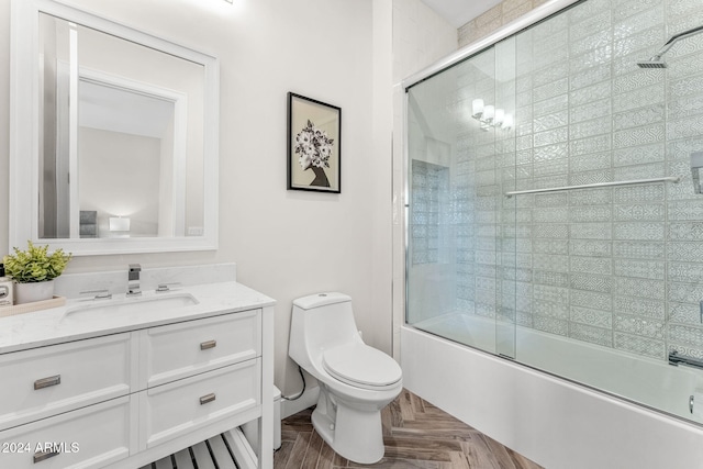 full bathroom with parquet flooring, vanity, toilet, and enclosed tub / shower combo