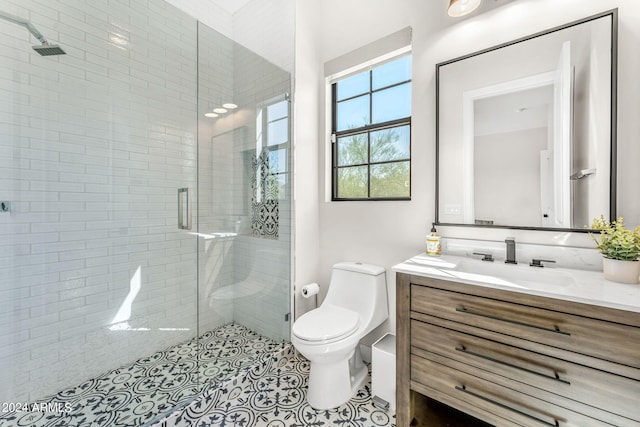 bathroom featuring walk in shower, vanity, tile patterned flooring, and toilet