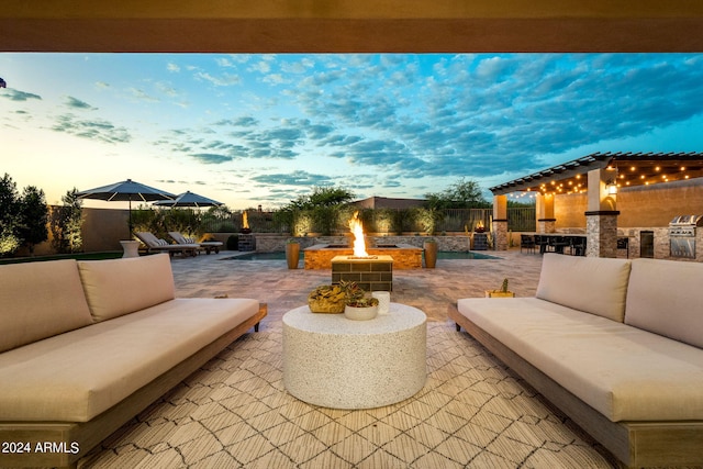 8742 E Villa Cassandra Dr, Scottsdale, AZ 85266 - patio terrace at dusk with an outdoor kitchen, an outdoor living space with a fire pit, and an outdoor bar