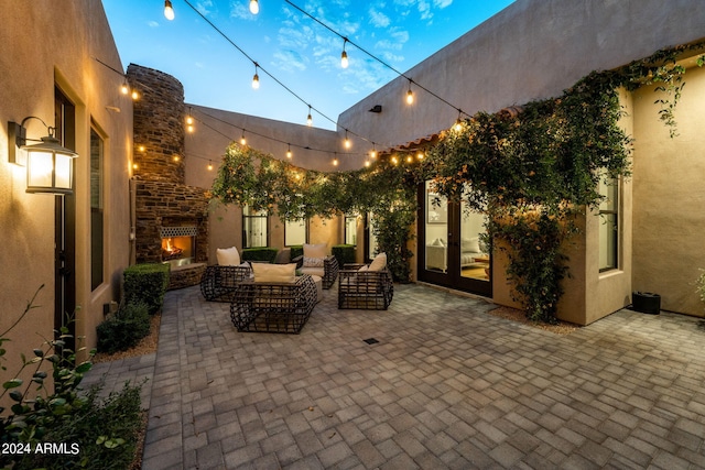 view of patio / terrace with an outdoor living space with a fireplace