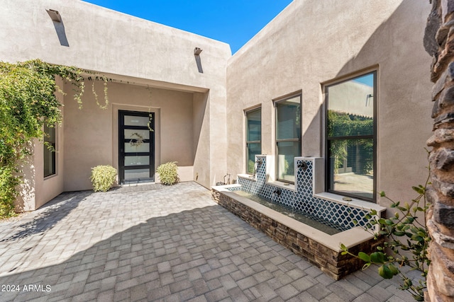 entrance to property with a patio