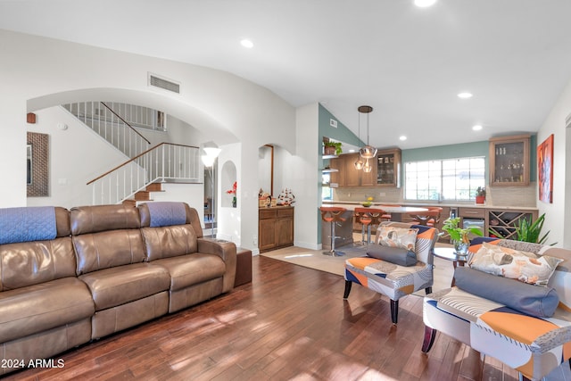 living room featuring hardwood / wood-style flooring and vaulted ceiling