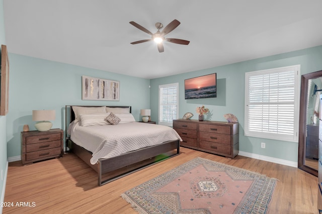 bedroom with ceiling fan and light hardwood / wood-style floors