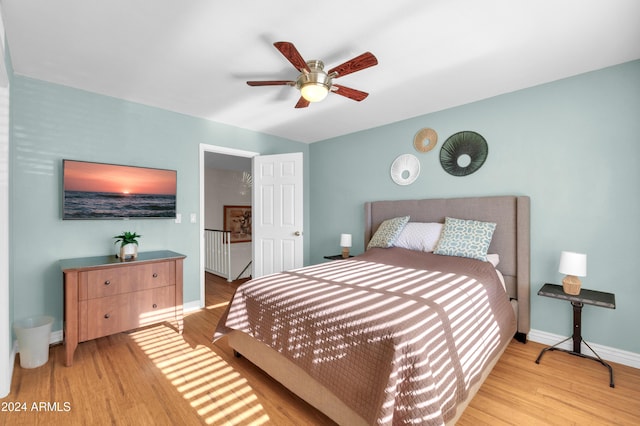 bedroom with ceiling fan and light wood-type flooring