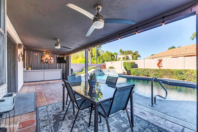 view of patio / terrace featuring ceiling fan and a fenced in pool