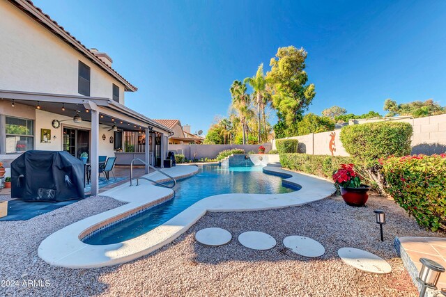 view of pool with ceiling fan, area for grilling, and a patio area