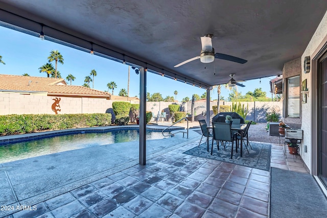 view of swimming pool with ceiling fan and a patio area