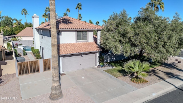 mediterranean / spanish-style home with a garage