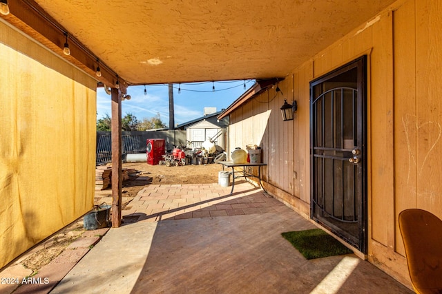 view of patio with a storage unit