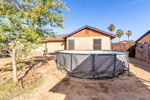 view of outbuilding featuring a fenced in pool