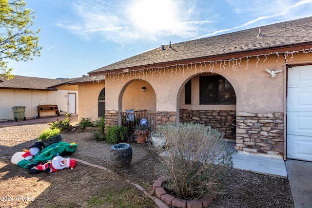 back of property with a garage