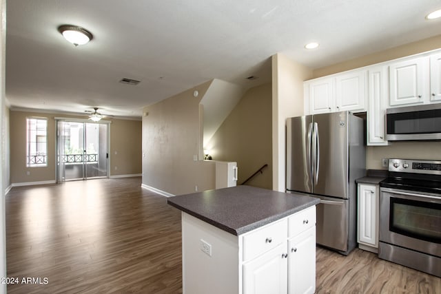 kitchen with ceiling fan, a center island, white cabinets, light hardwood / wood-style floors, and stainless steel appliances