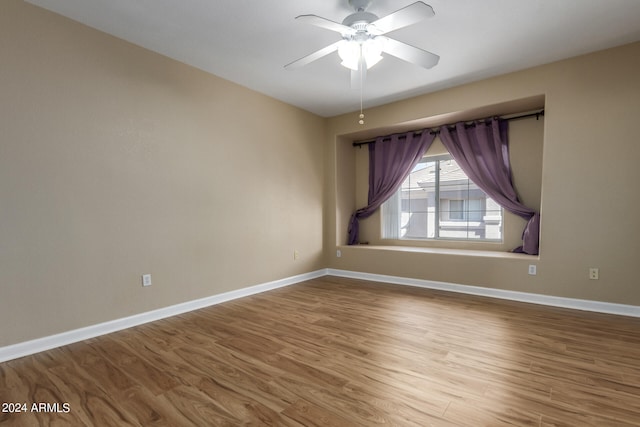 unfurnished room with hardwood / wood-style floors and ceiling fan