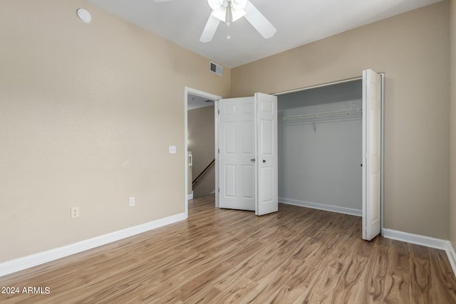 unfurnished bedroom with a closet, light hardwood / wood-style flooring, and ceiling fan