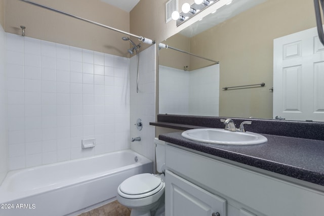 full bathroom featuring tiled shower / bath, toilet, tile floors, and large vanity