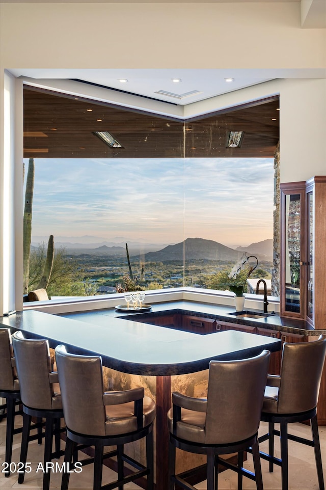 interior space featuring a mountain view and sink