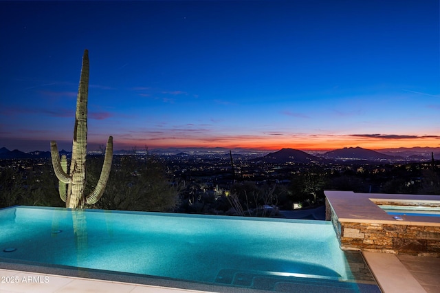 pool at dusk with a mountain view