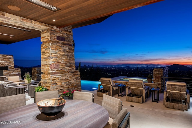 view of patio terrace at dusk