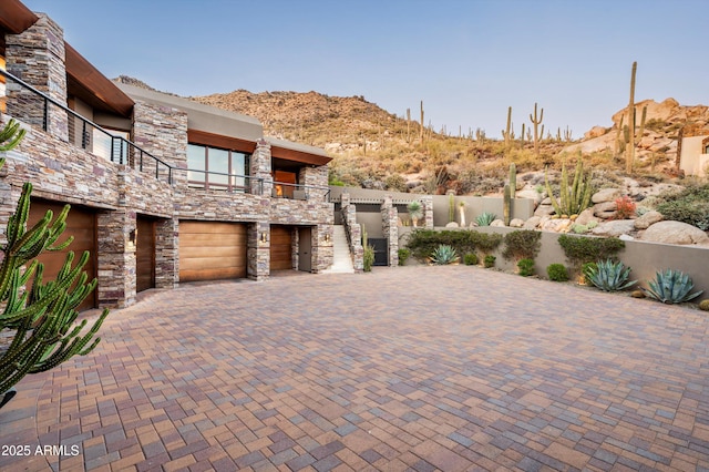 view of patio / terrace with a mountain view, a balcony, and a garage