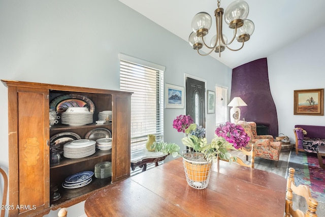 dining area with an inviting chandelier and lofted ceiling