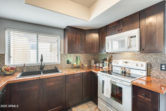 kitchen with tasteful backsplash, dark brown cabinets, sink, and white appliances