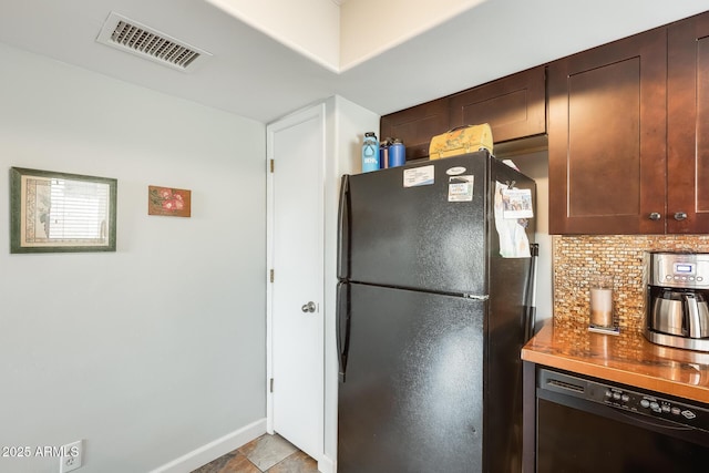 kitchen featuring tasteful backsplash, black appliances, and dark brown cabinetry