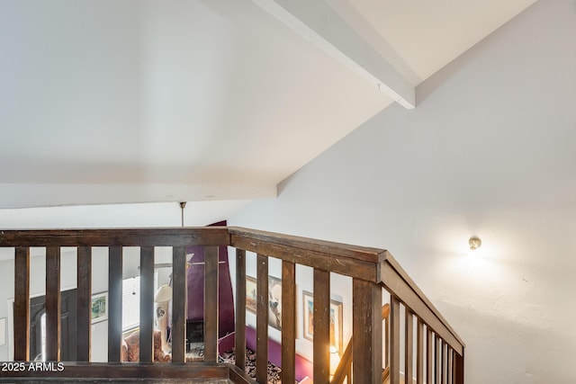 corridor with vaulted ceiling with beams