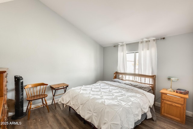 bedroom with dark wood-type flooring and vaulted ceiling