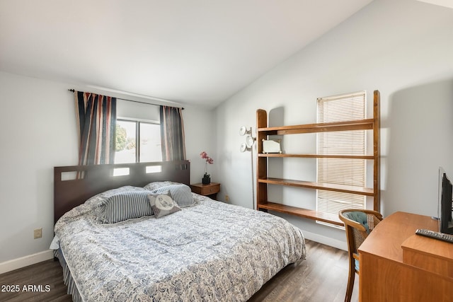 bedroom featuring vaulted ceiling and dark wood-type flooring