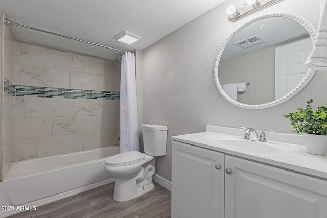 full bathroom with toilet, a textured ceiling, vanity, shower / bath combo with shower curtain, and hardwood / wood-style flooring