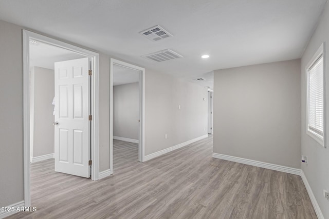 spare room with light wood-type flooring