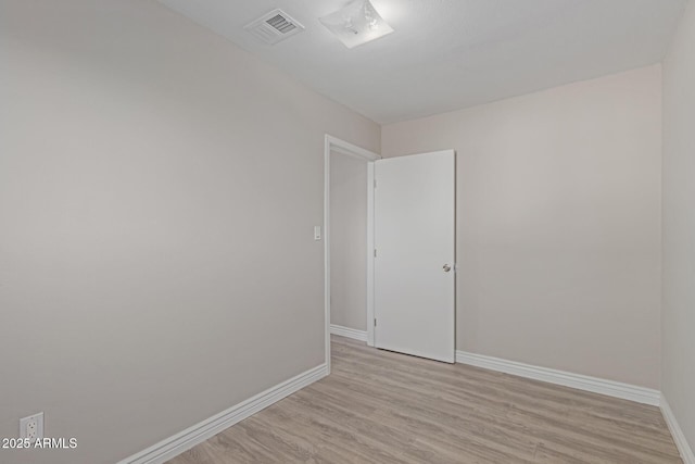 unfurnished room with light hardwood / wood-style floors