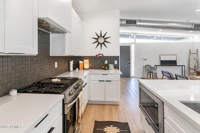 1212 E Indianola Ave, Phoenix, AZ 85014 - kitchen featuring visible vents, light wood-style floors, appliances with stainless steel finishes, and premium range hood