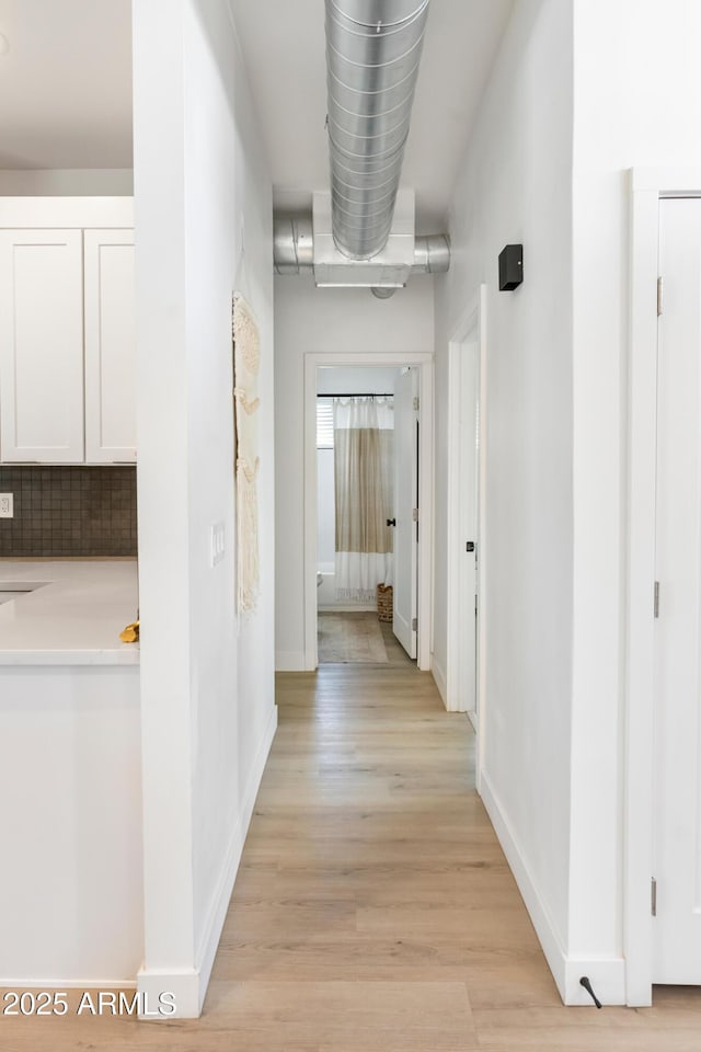1212 E Indianola Ave, Phoenix, AZ 85014 - corridor with baseboards and light wood-style floors