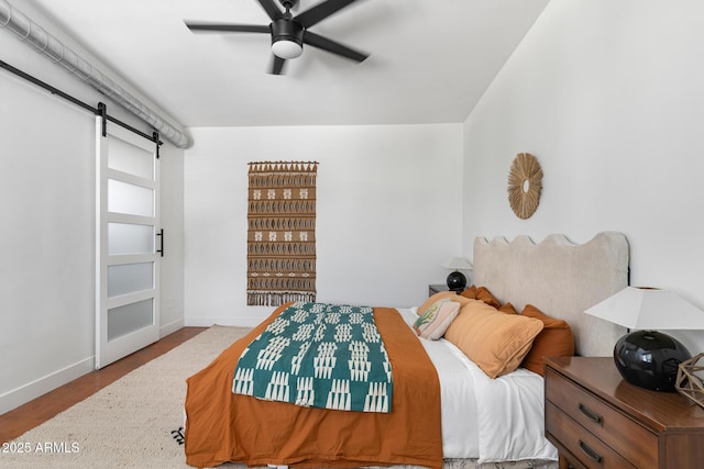1212 E Indianola Ave, Phoenix, AZ 85014 - bedroom featuring baseboards, ceiling fan, and a barn door