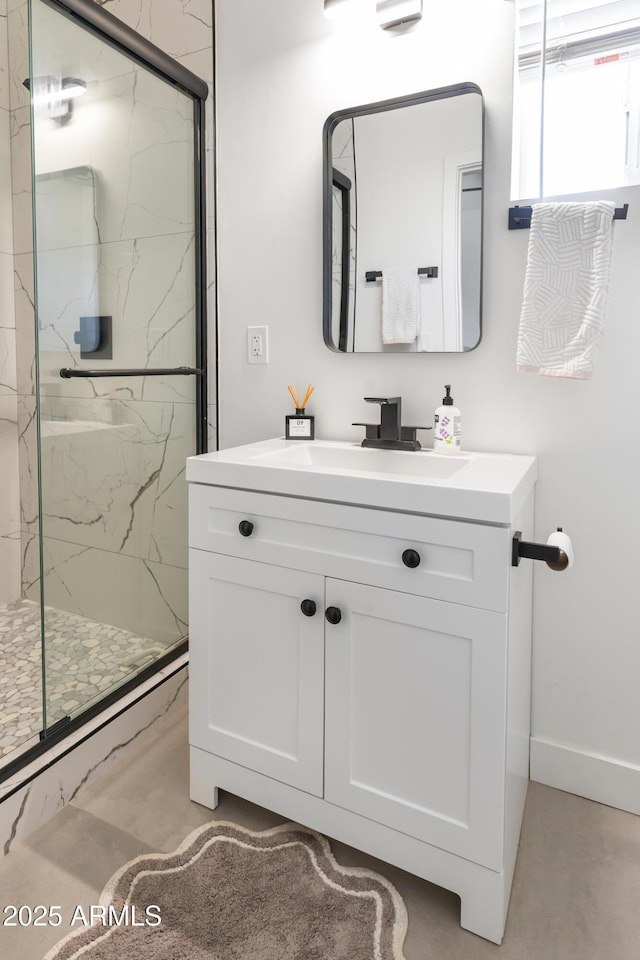 1212 E Indianola Ave, Phoenix, AZ 85014 - full bathroom featuring baseboards, vanity, and a marble finish shower