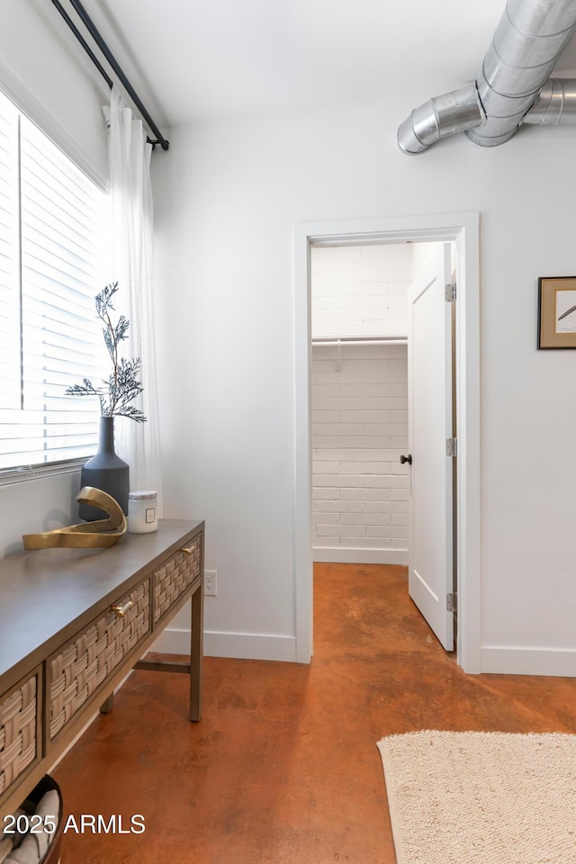 1212 E Indianola Ave, Phoenix, AZ 85014 - hall with baseboards and concrete flooring