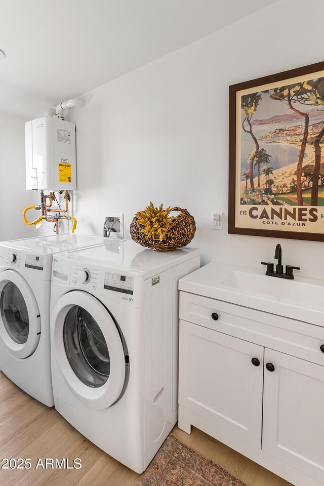 1212 E Indianola Ave, Phoenix, AZ 85014 - clothes washing area featuring water heater, cabinet space, a sink, and washer and clothes dryer