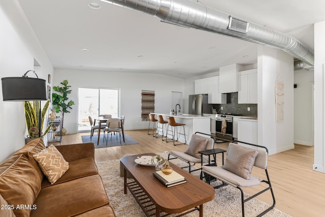 1212 E Indianola Ave, Phoenix, AZ 85014 - living area featuring baseboards, visible vents, recessed lighting, and light wood-style floors