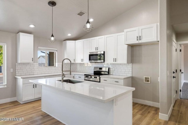 780 E Cobble Ln, Taylor, AZ 85939 - kitchen with appliances with stainless steel finishes, a sink, decorative backsplash, white cabinets, and lofted ceiling
