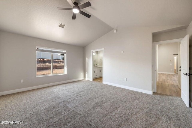 780 E Cobble Ln, Taylor, AZ 85939 - unfurnished bedroom with light colored carpet, baseboards, lofted ceiling, and connected bathroom